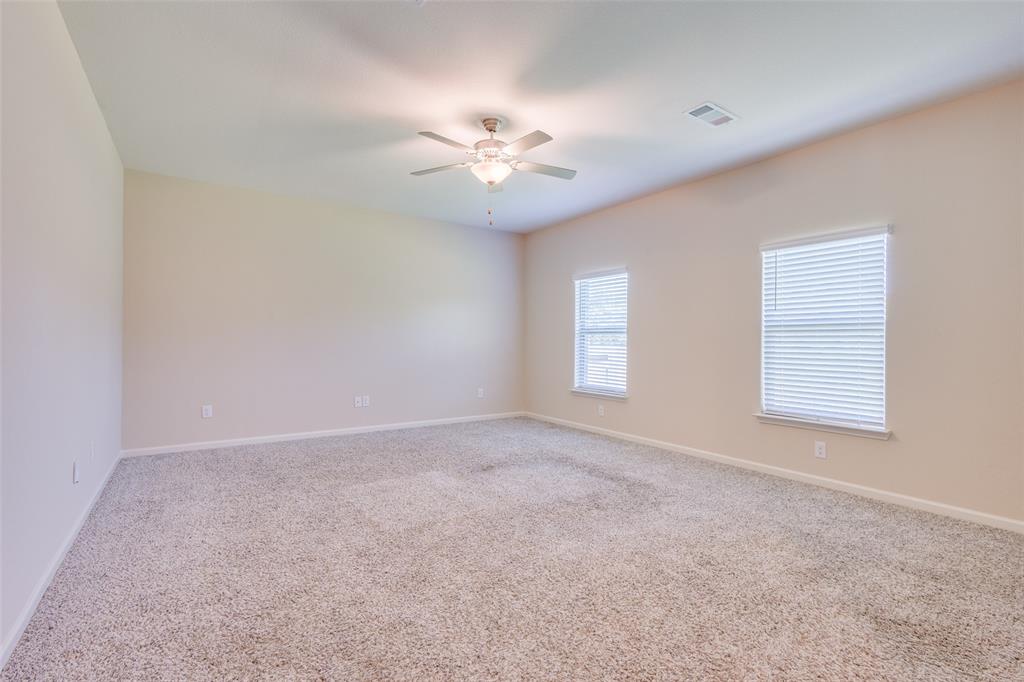 2256 Cashmere Way Princeton, TX 75407 - Photo 26 of 36 an empty room with windows and fan