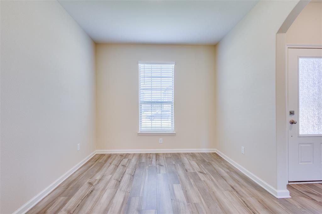 2256 Cashmere Way Princeton, TX 75407 - Photo 7 of 36 a view of a room that has wooden floor and window in it