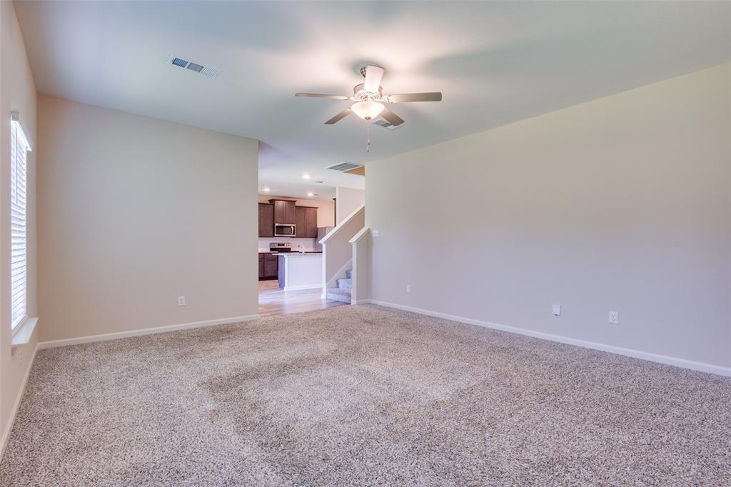 2256 Cashmere Way Princeton, TX 75407 - Photo 9 of 36 a view of empty room with a ceiling fan and window