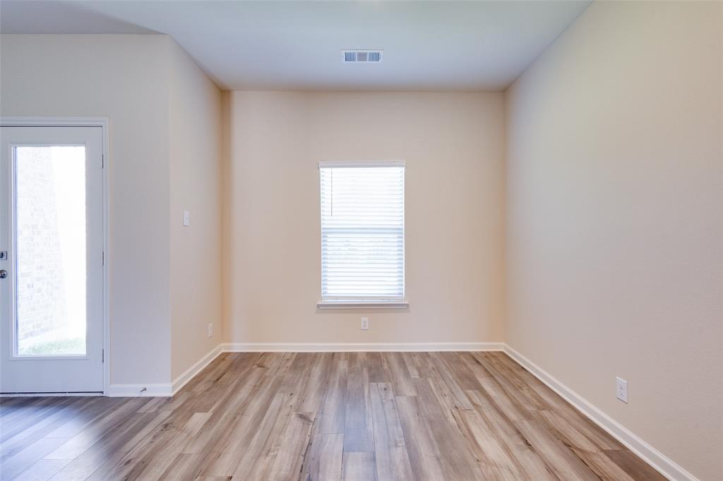 2256 Cashmere Way Princeton, TX 75407 - Photo 10 of 36 an empty room with wooden floor and windows
