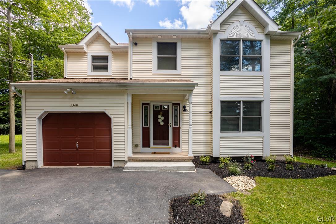 3348 Oberon Road Tobyhanna, PA 18466 - Photo 1 of 22 a front view of a house with a yard and garage