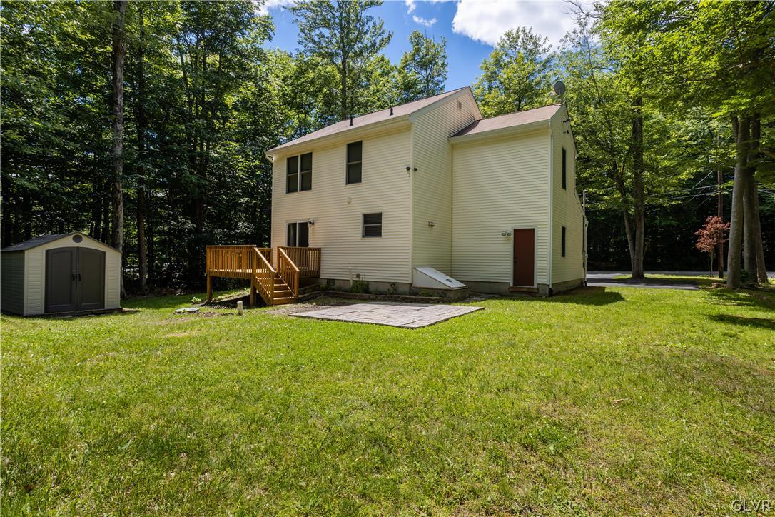 3348 Oberon Road Tobyhanna, PA 18466 - Photo 22 of 22 a view of a backyard with table and chairs a barbeque and a large trees