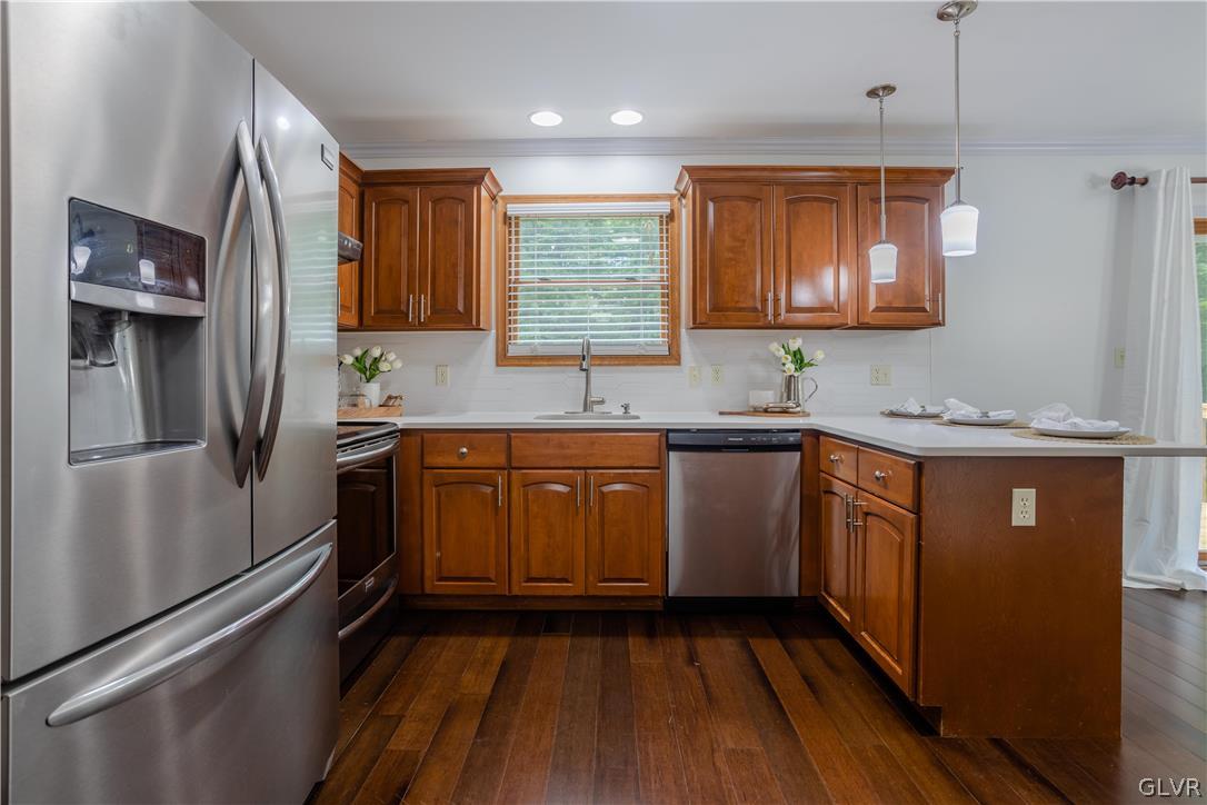 3348 Oberon Road Tobyhanna, PA 18466 - Photo 9 of 22 a kitchen with stainless steel appliances granite countertop a refrigerator a sink dishwasher a stove and white countertops with wooden floor