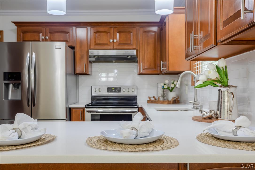 3348 Oberon Road Tobyhanna, PA 18466 - Photo 10 of 22 a kitchen with kitchen island granite countertop a sink and a stove
