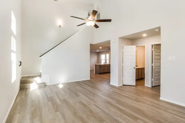 a view of an empty room and wooden floor