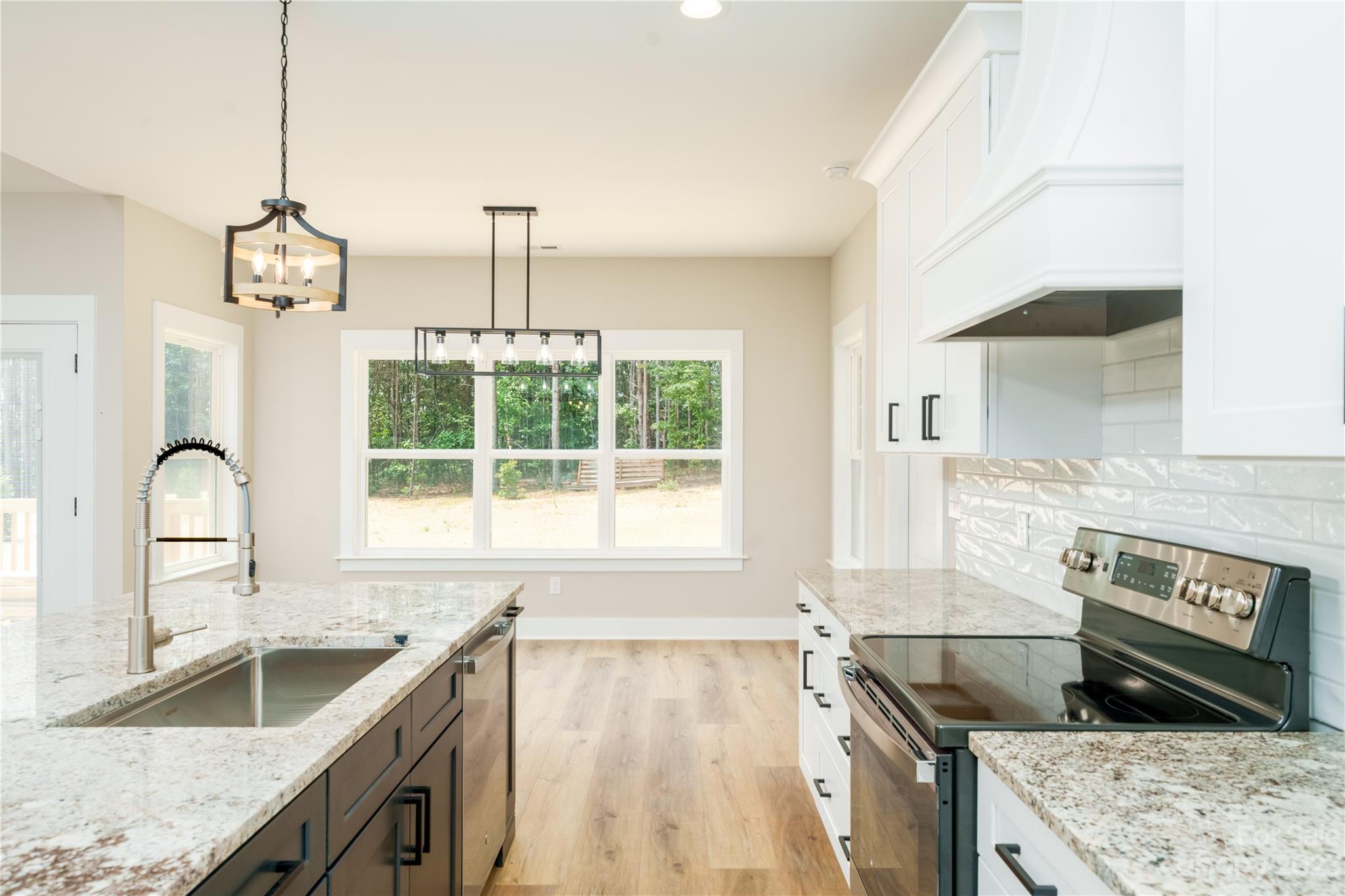 2512 Shuford Road, Unit 7A Lincolnton, NC 28092 - Photo 11 of 27 a kitchen with a stove a sink and a granite counter tops