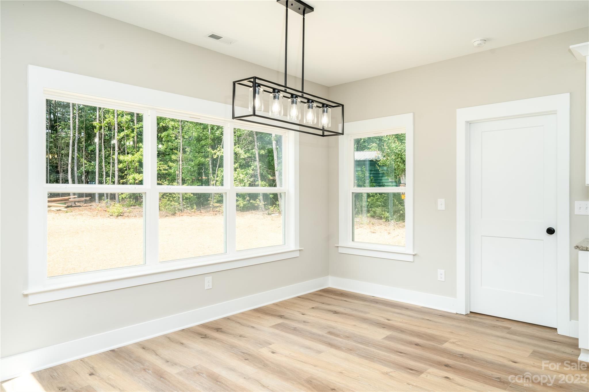 2512 Shuford Road, Unit 7A Lincolnton, NC 28092 - Photo 12 of 27 a view of an empty room with wooden floor and a window