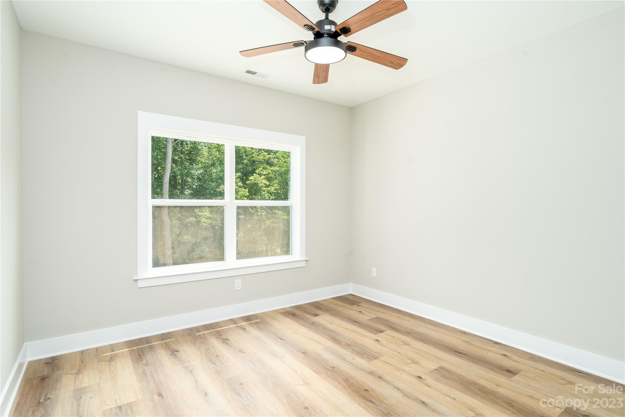 2512 Shuford Road, Unit 7A Lincolnton, NC 28092 - Photo 23 of 27 an empty room with a window and a ceiling fan