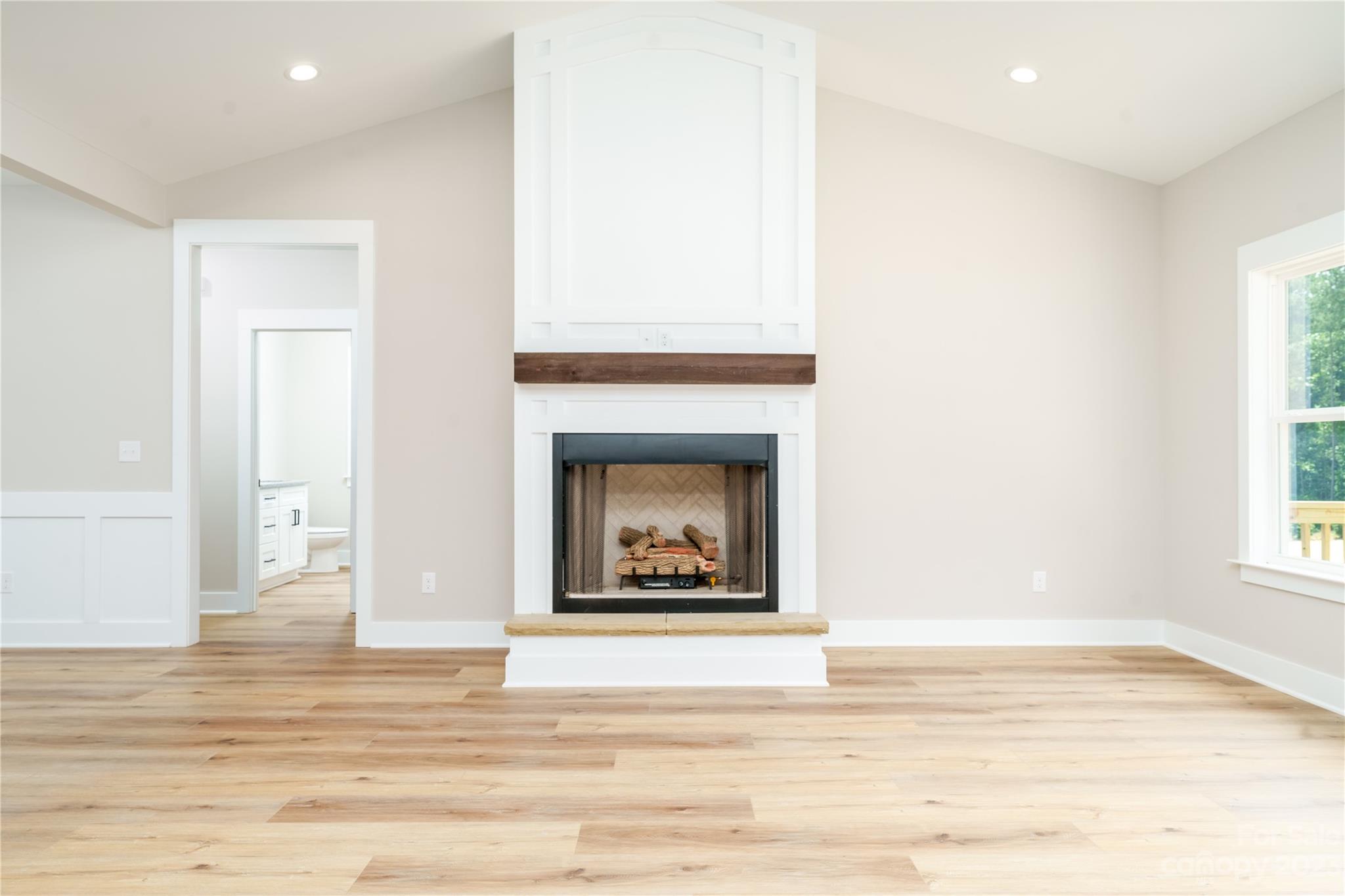 2512 Shuford Road, Unit 7A Lincolnton, NC 28092 - Photo 3 of 27 a view of a livingroom with a fireplace a ceiling fan and wooden floor