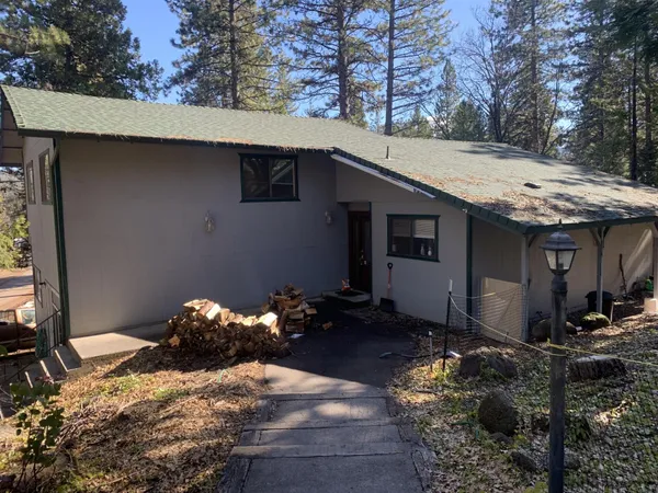 a backyard of a house with table and chairs