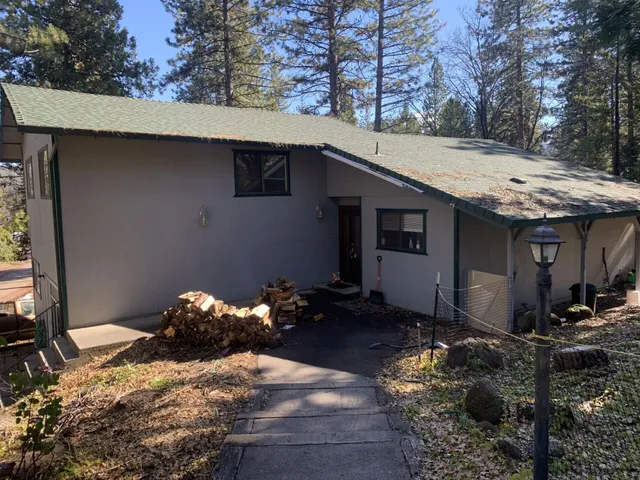 a backyard of a house with table and chairs