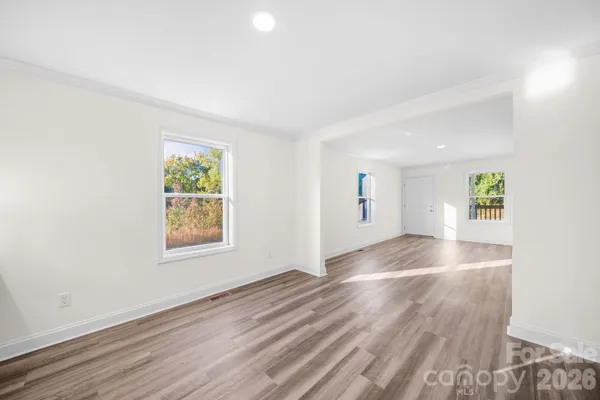 an empty room with windows and entrance