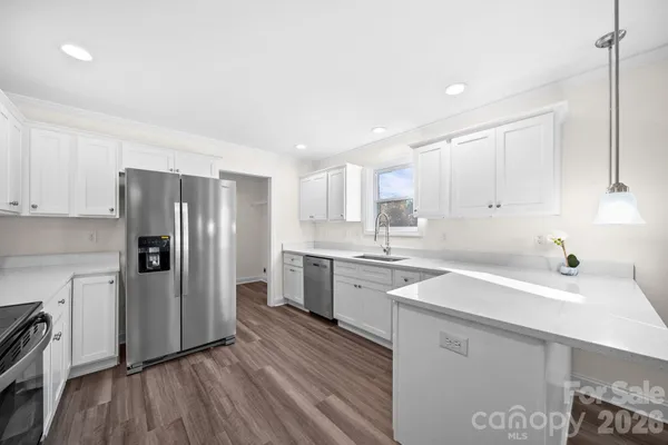 a kitchen with a sink stainless steel appliances and cabinets