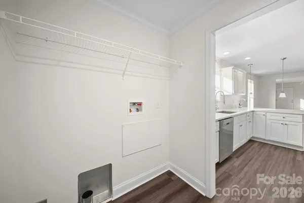 a kitchen with cabinets and wooden floor