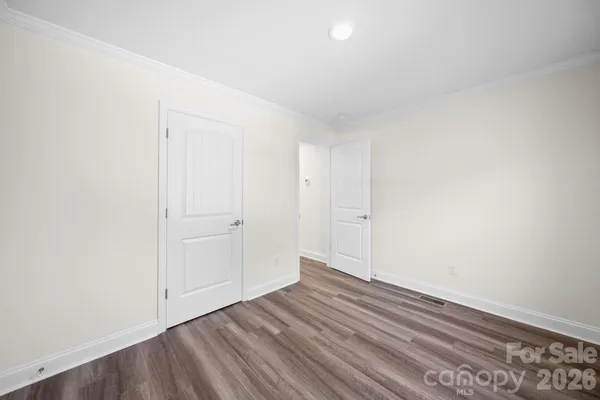 a view of an empty room and wooden floor