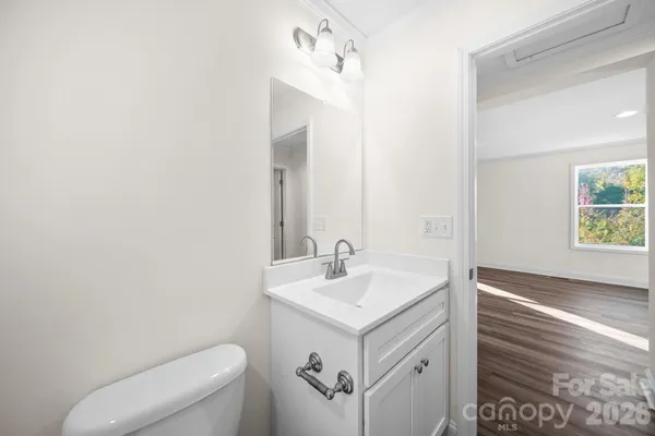 a bathroom with a sink a toilet and a mirror