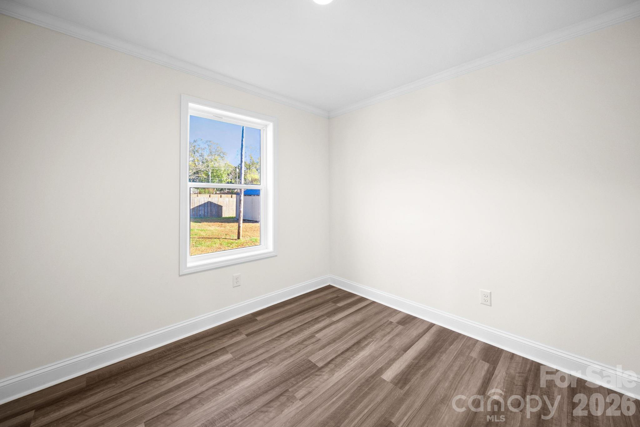 159 Hallman Street Cherryville, NC 28021 - Photo 24 of 37 a view of an empty room with wooden floor and a window