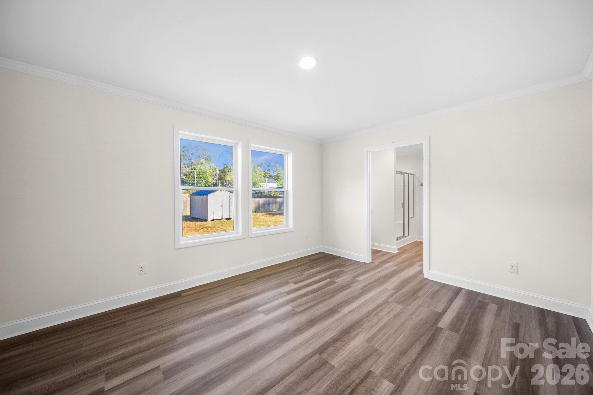 159 Hallman Street Cherryville, NC 28021 - Photo 27 of 37 an empty room with wooden floor and windows