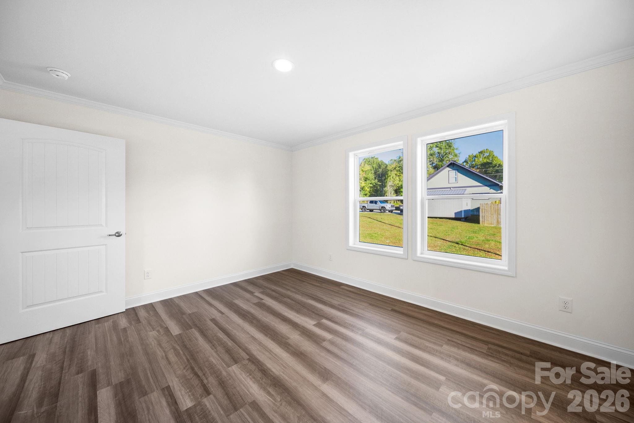 159 Hallman Street Cherryville, NC 28021 - Photo 28 of 37 a view of an empty room with wooden floor and a window