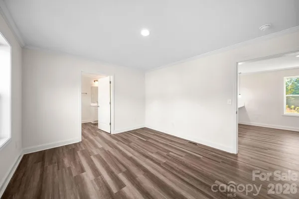 a view of an empty room and wooden floor