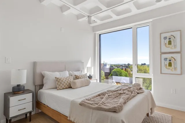 a bedroom with a large bed and a window
