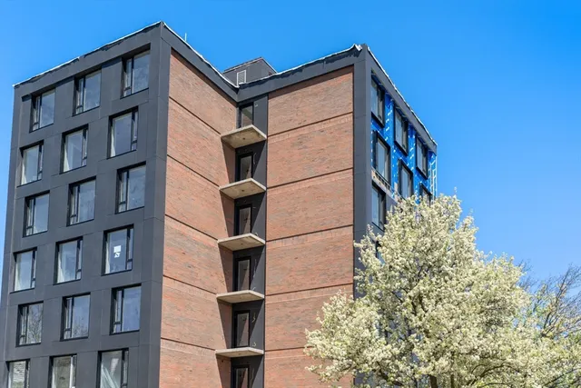 a brick building with a tree in front of it