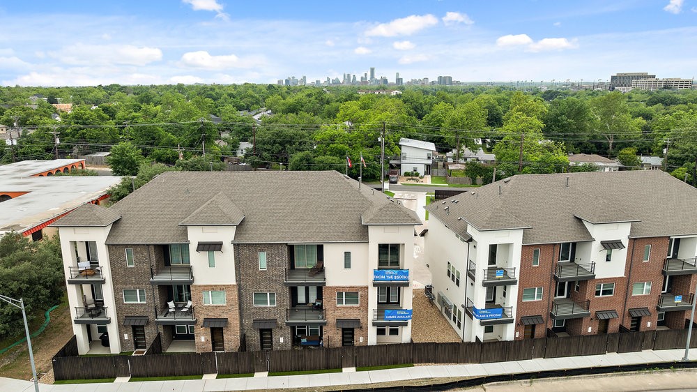 a aerial view of a residential apartment building with a yard