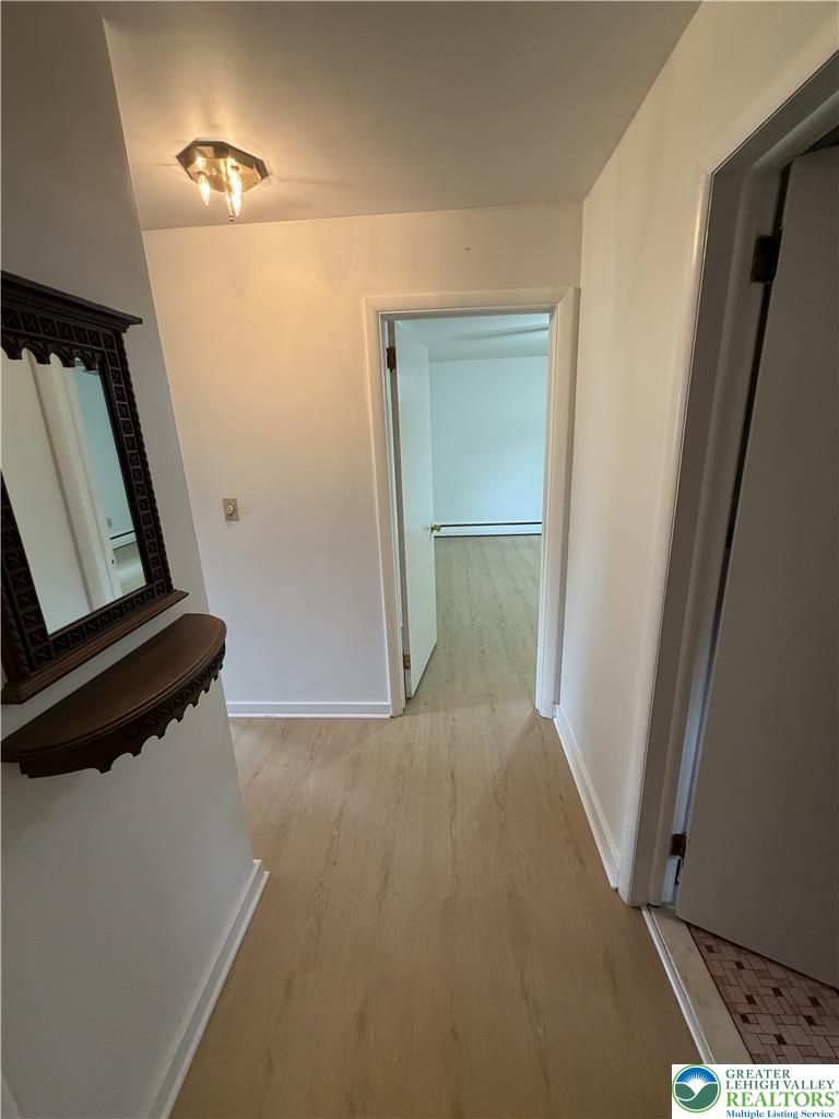 5391 Chapmans Road, Unit 2 Orefield, PA 18069 - Photo 10 of 22 A welcoming entryway with natural wood-look flooring leads to inviting interior spaces.