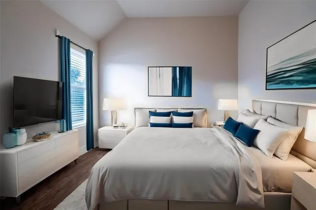 a bedroom with a bed and a flat screen tv