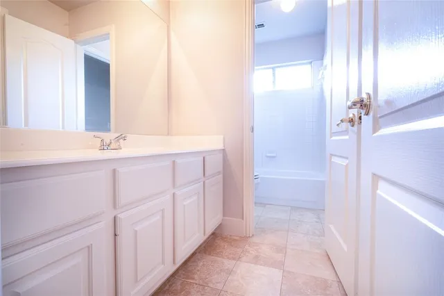 a bathroom with a sink a vanity and a mirror