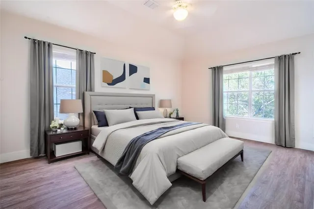 a bedroom with a large bed and a window