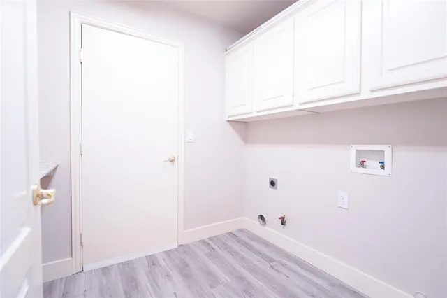 a view of a closet with wooden floor