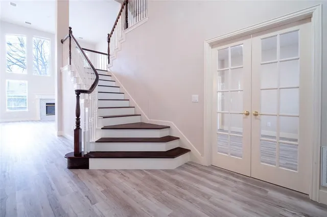 a view of a room with wooden floor and white walls