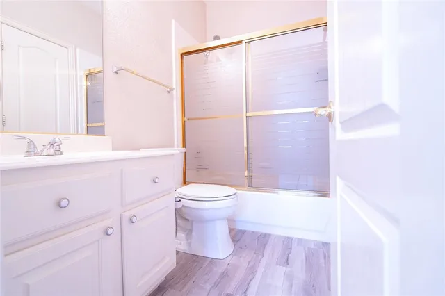 a bathroom with a sink a toilet a shower and a mirror