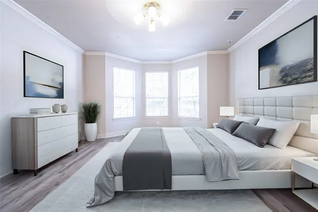 a bedroom with a large bed and a flat screen tv