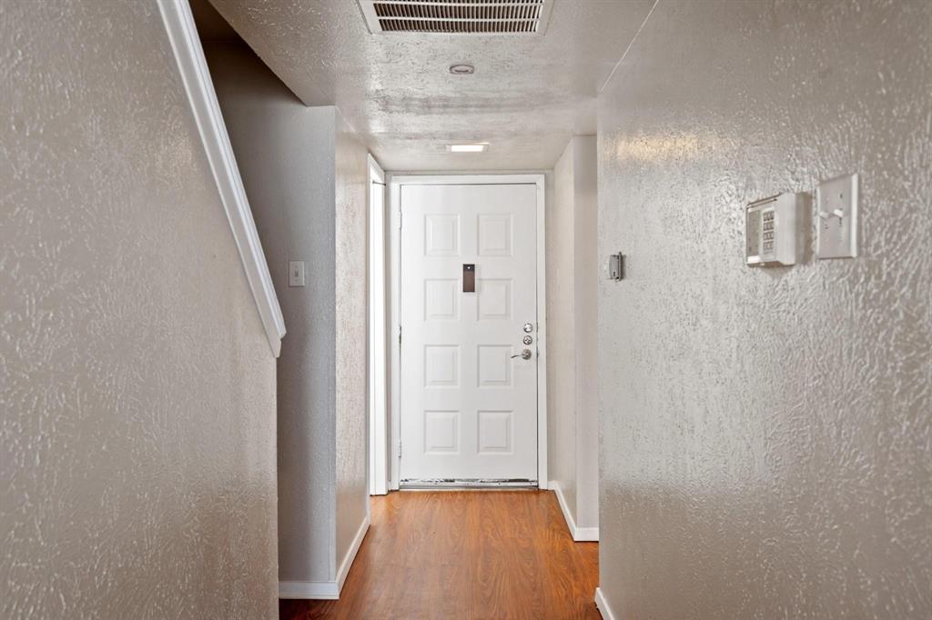 4543 North O'Connor Road, Unit 1247 Irving, TX 75062 - Photo 3 of 25 a view of a hallway with wooden floor and a bathroom