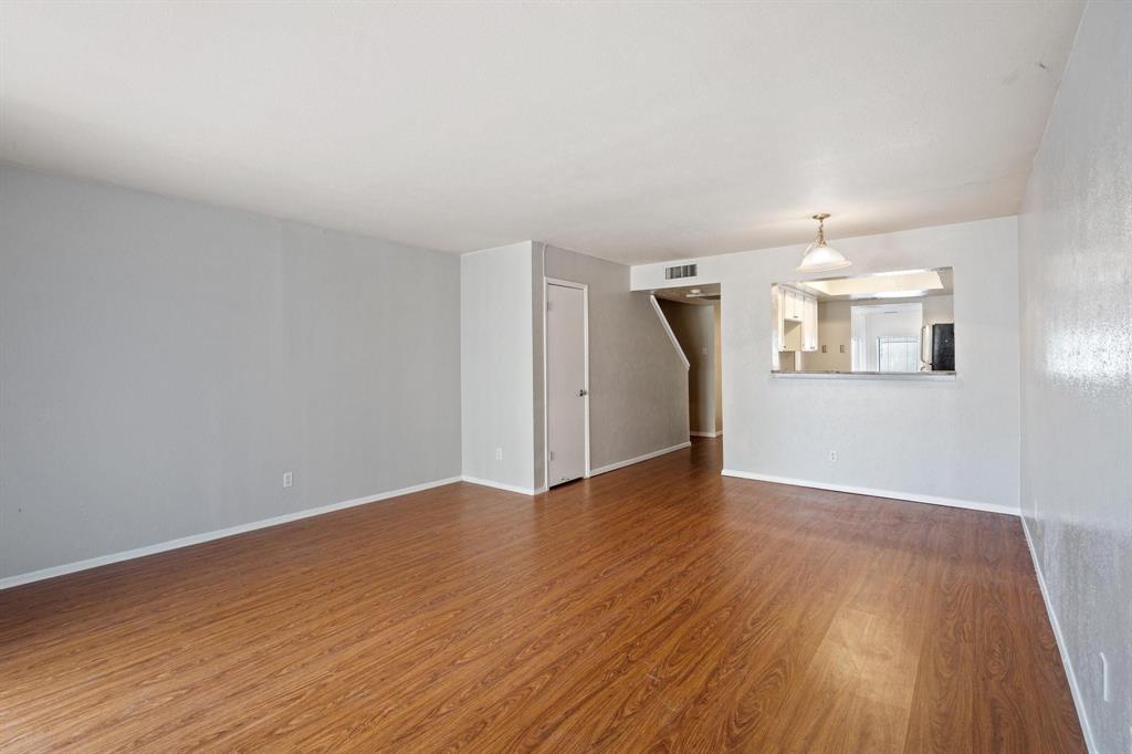4543 North O'Connor Road, Unit 1247 Irving, TX 75062 - Photo 4 of 25 wooden floor in an empty room with a window