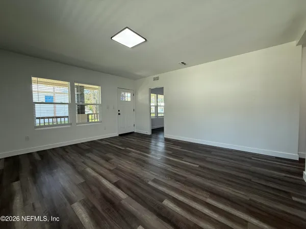 wooden floor in an empty room with a window