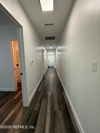 a view of gallery with wooden floor