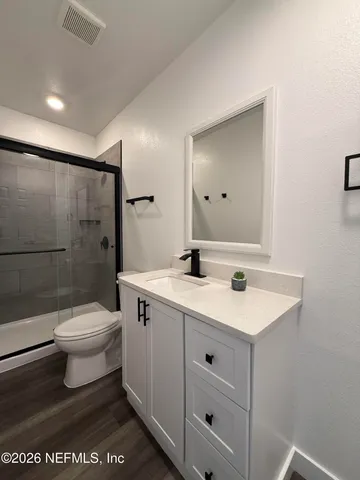 a bathroom with a toilet a sink and a mirror