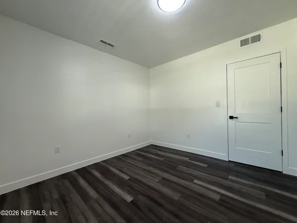 a view of room with wooden floor