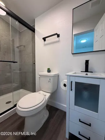 a bathroom with a toilet sink and shower