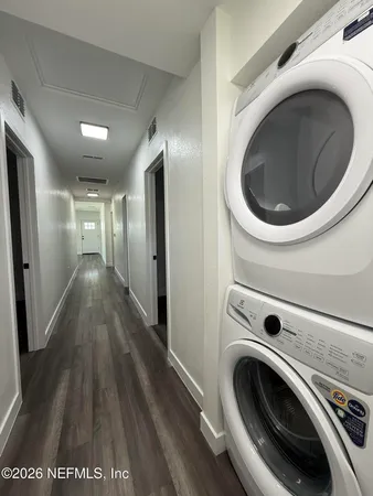 a view of a hallway with washer and dryer