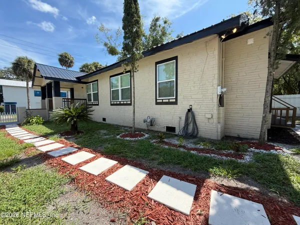 a backyard of a house with table and chairs