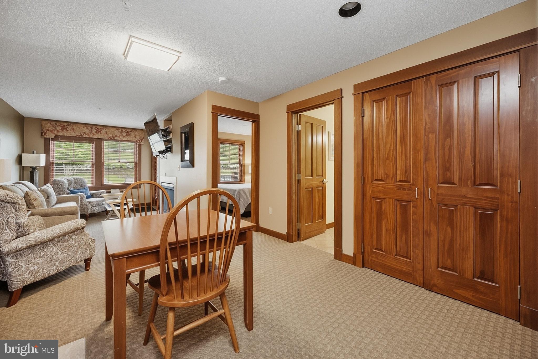 565 Glendale Road, Unit 208A Oakland, MD 21550 - Photo 8 of 51 a dining room with furniture and window
