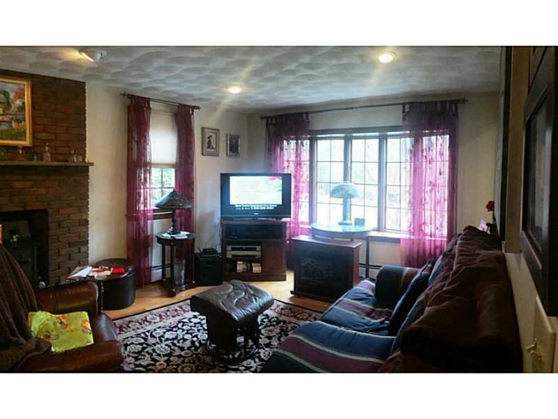 919 Whaley Hollow Road Coventry, RI 02816 - Photo 11 of 25 Living Room. bright living room with fireplace and hardwoods