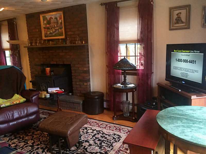 919 Whaley Hollow Road Coventry, RI 02816 - Photo 14 of 25 Living Room. wood stove in fireplace