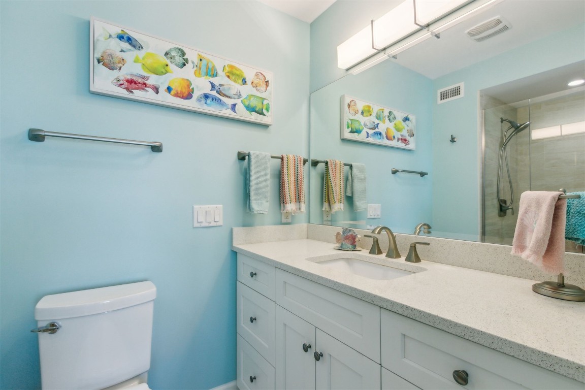 95078 Sandpiper Loop Fernandina Beach, FL 32034 - Photo 23 of 38 a bathroom with a sink mirror and a toilet