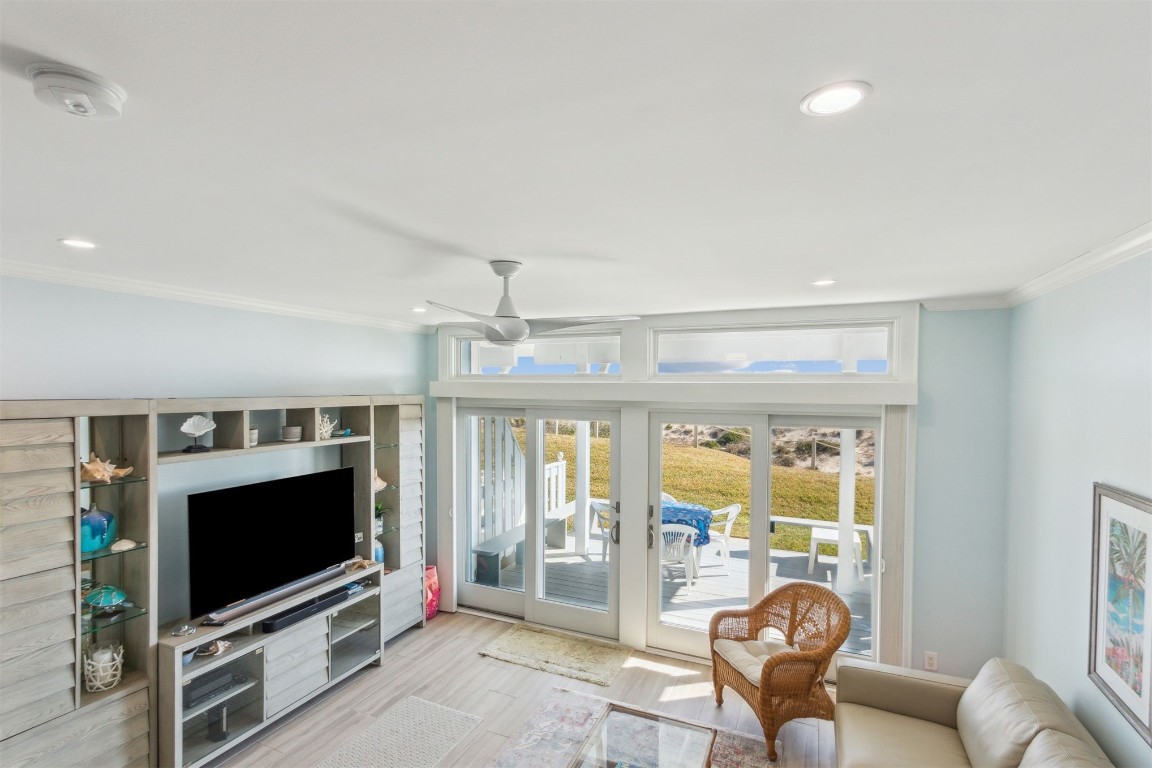 95078 Sandpiper Loop Fernandina Beach, FL 32034 - Photo 5 of 38 a living room with furniture a flat screen tv and a floor to ceiling window