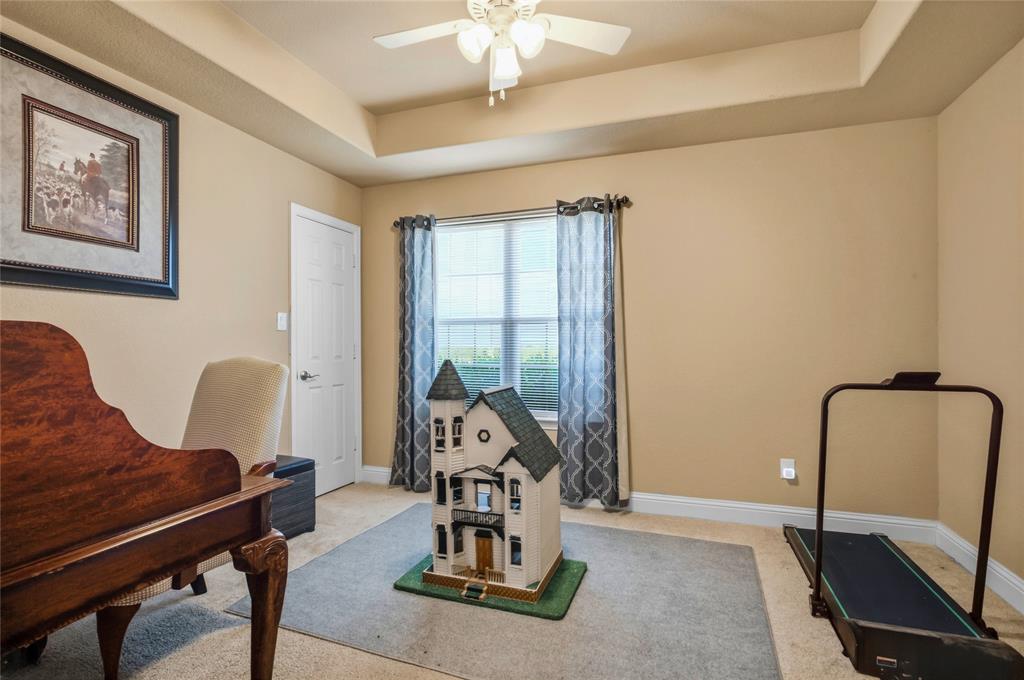3911 Bennett Road Howe, TX 75459 - Photo 24 of 34 The 4th bedroom is basically and exercise room and a playroom, but it is a nice bedroom with another beaufiful tray ceiling that is on the front side of the house